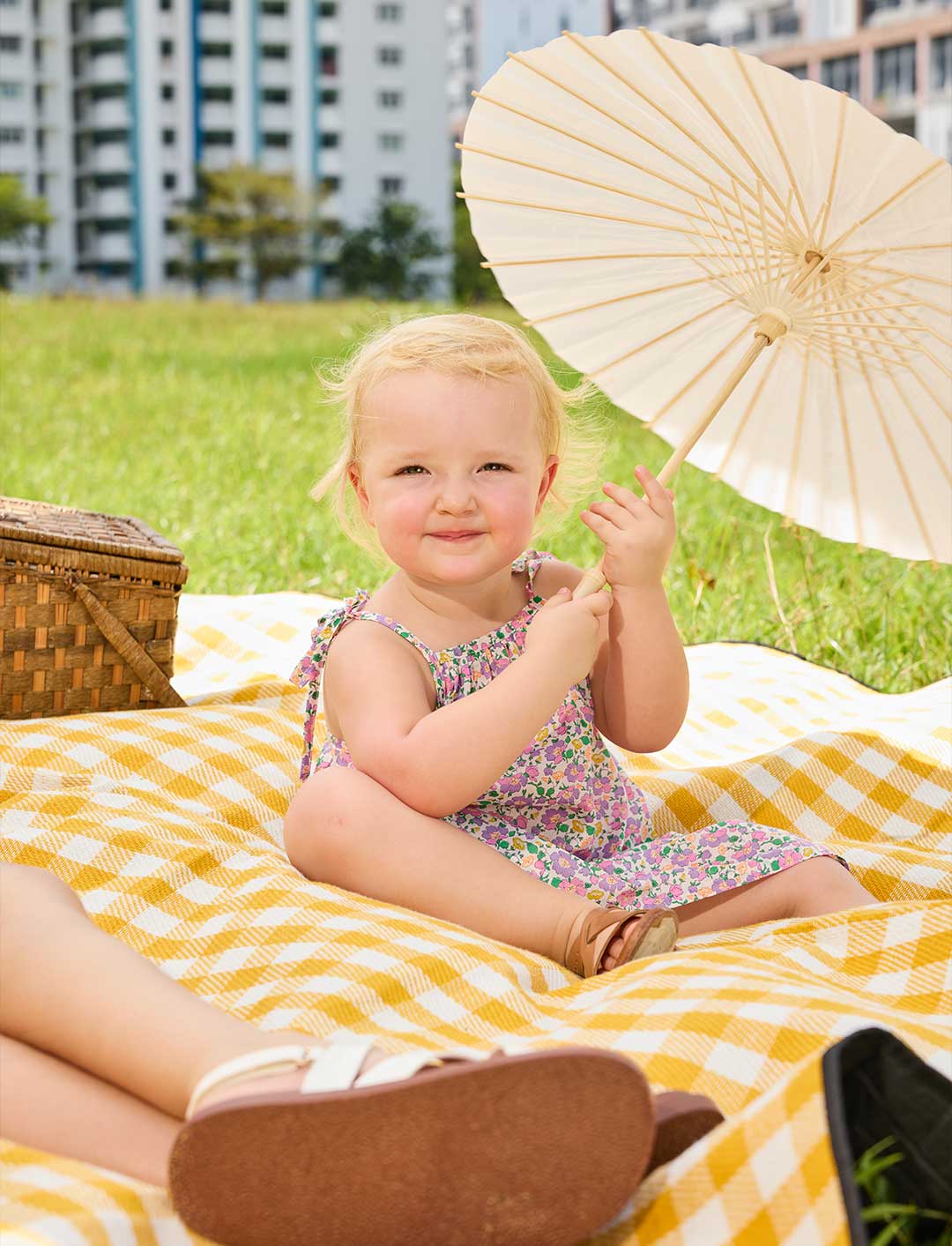A young girl modelling a dress in liberty print