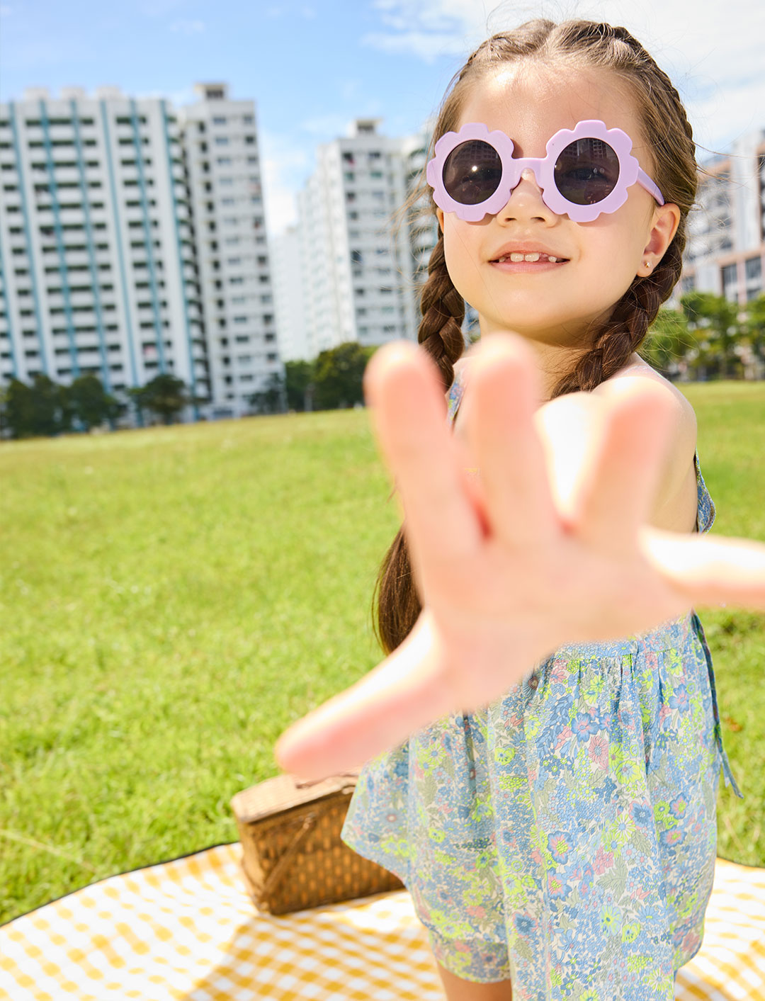Girl in purple sunglasses wearing liberty print clothing from ce-jour la