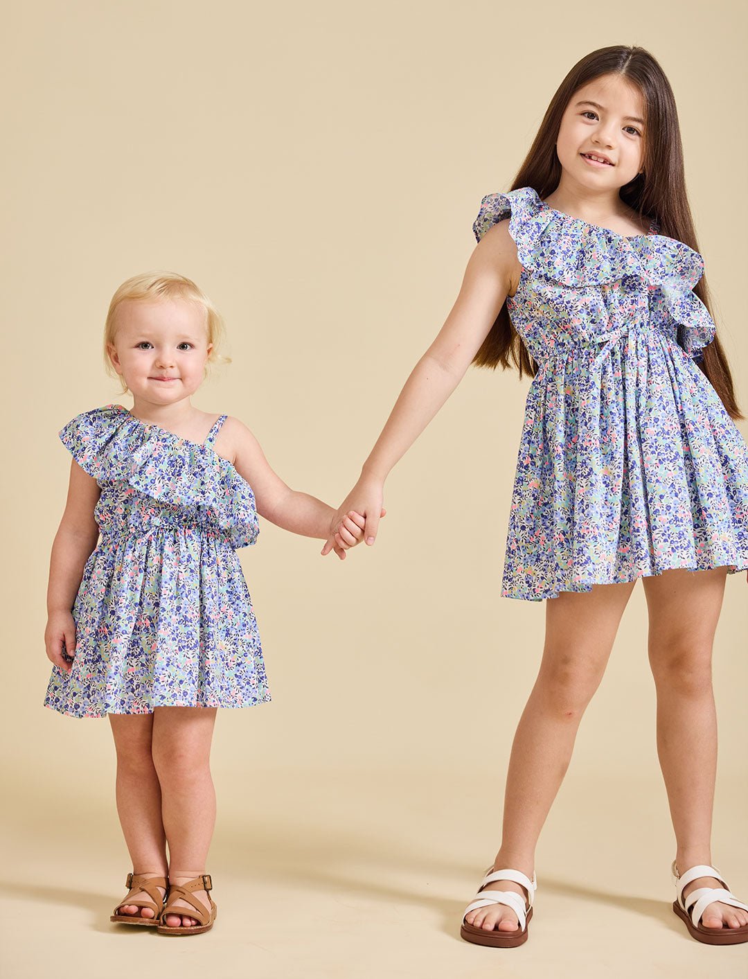 two girls wearing the Daisy dress holding hands - ce-jour la