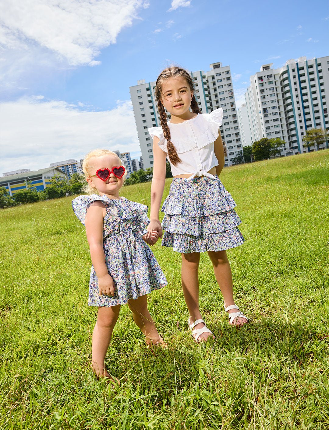 Young girl wearing the Daisy dress and heart-shaped sunglasses and a girl wearing the Daisy skirt - ce-jour la