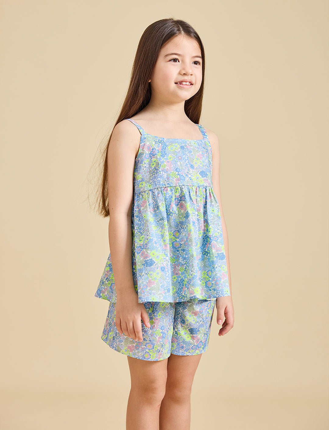 Girl wearing the delilah liberty print set with a beige background
