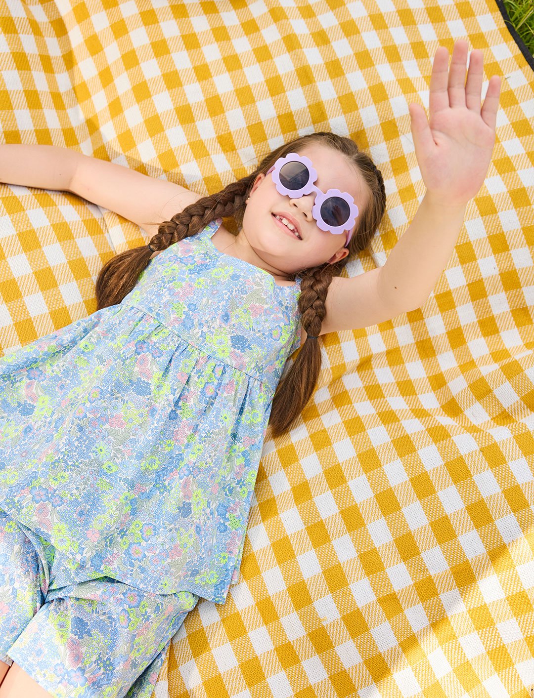 Girl lying on a picnic blanket wearing the delilah liberty print set - ce-jour la