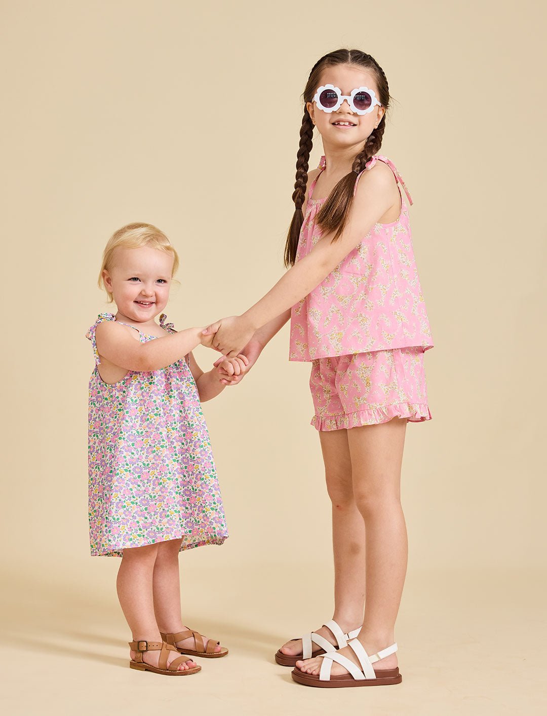 Young girl holding hands wearing the Fleur Liberty Print dress from ce-jour la