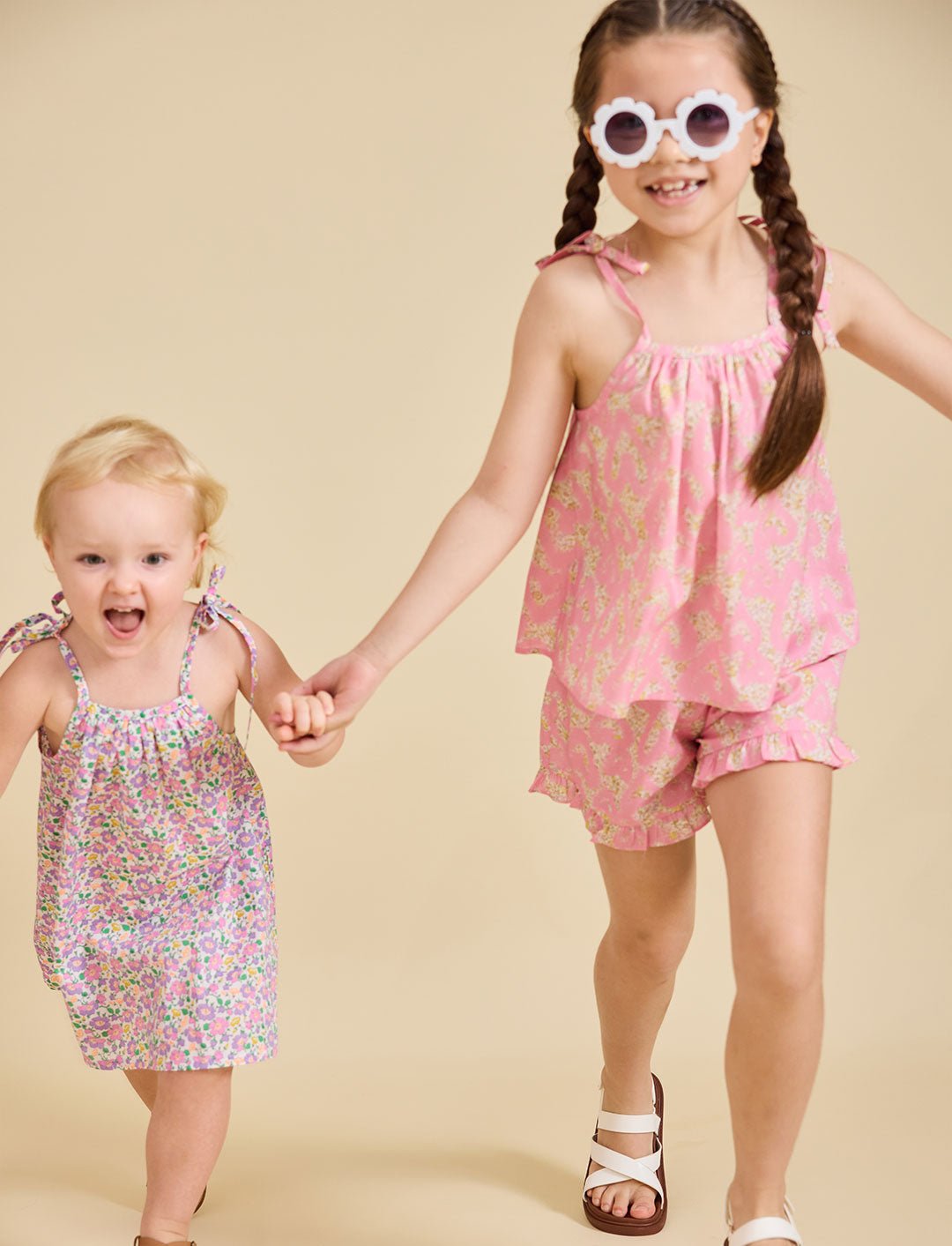 Young girl running towards the camera wearing the ce-jour la fleur dress
