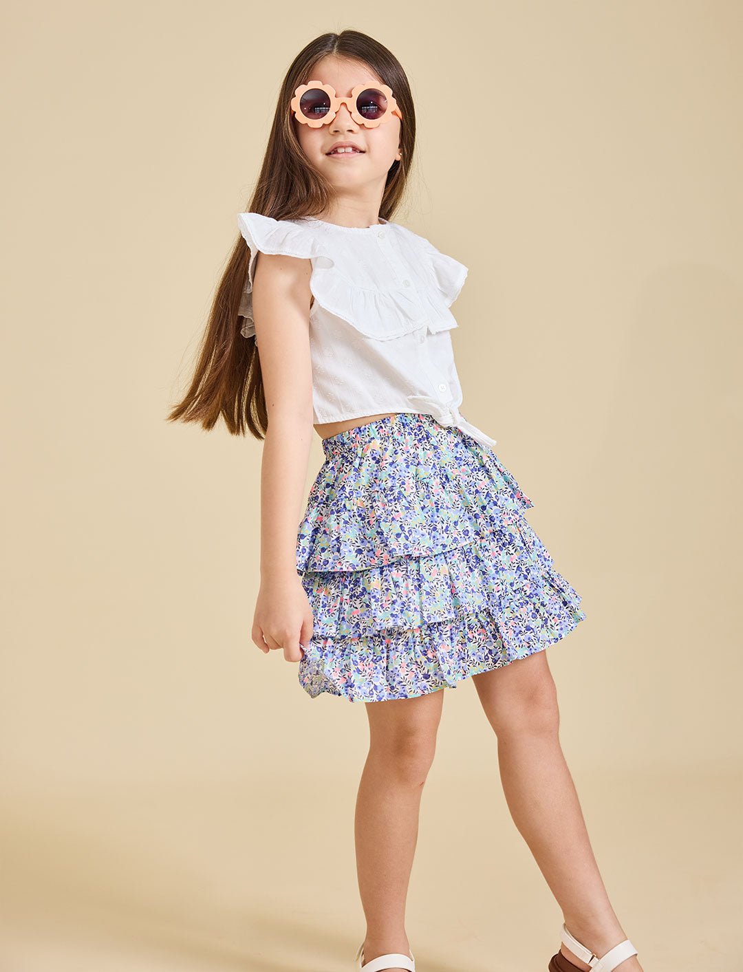 Girl wearing the Odette liberty print skirt with a beige background - ce-jour la