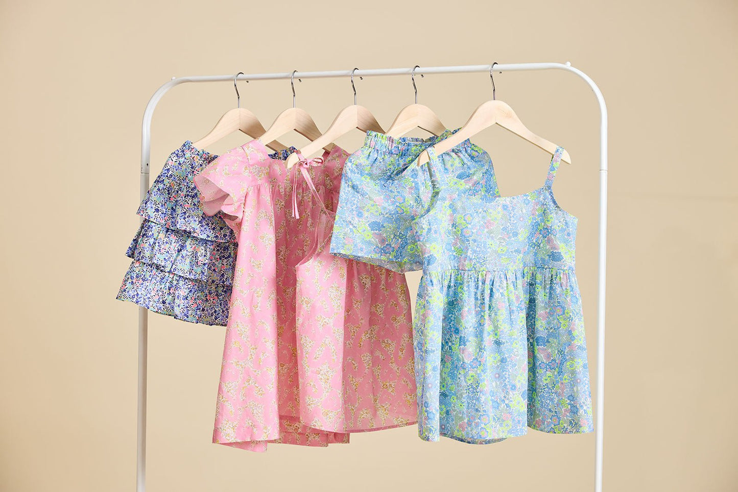 A selection of liberty print dresses on a clothes rail from ce-jour la