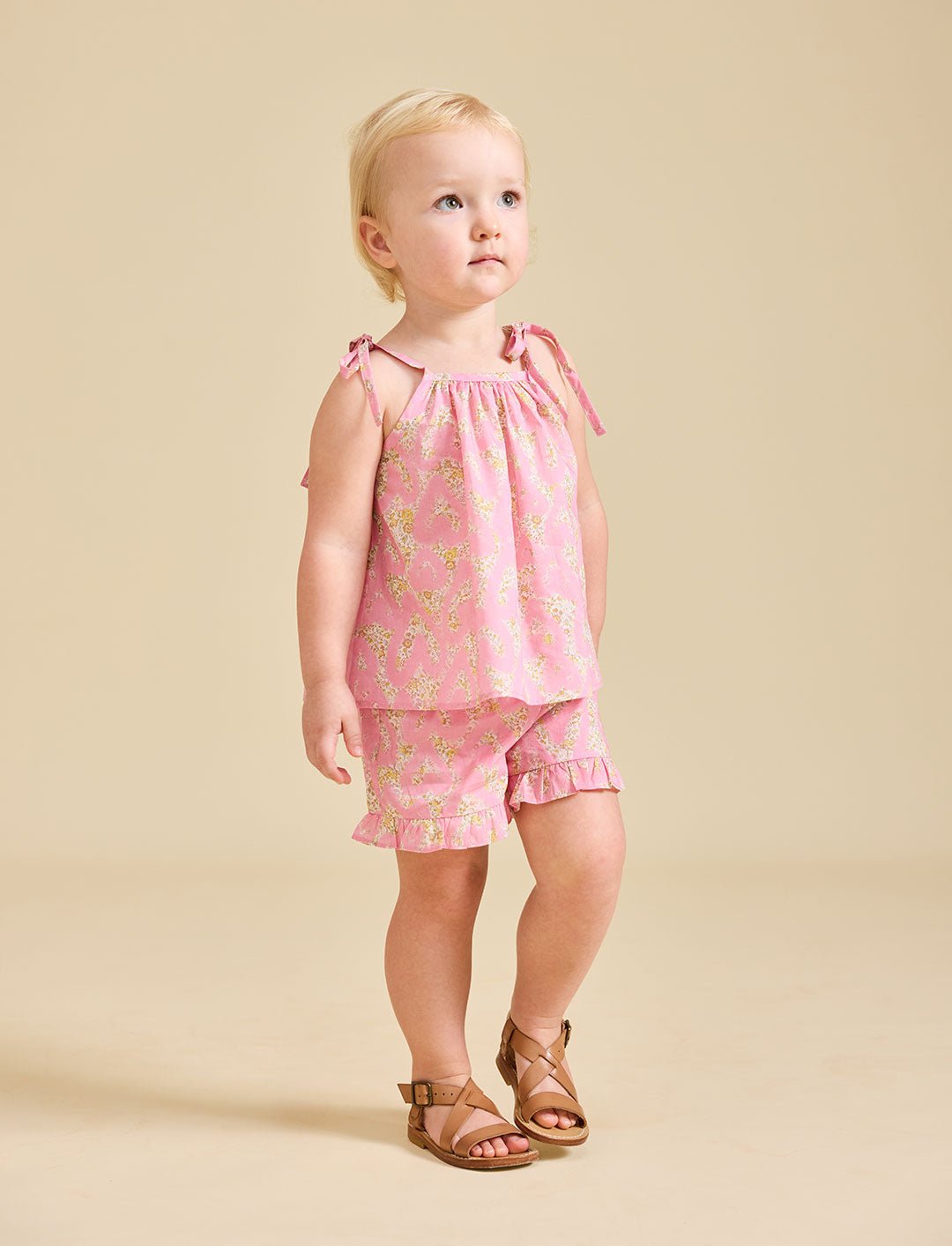 Girl modelling the pink Rosalie set in Liberty fabric and brown sandals - ce-jour la