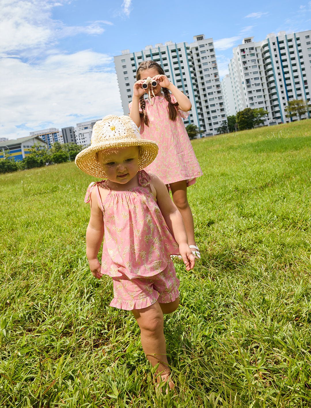 two girls modelling the Rosalie liberty print clothing line in a grassy field