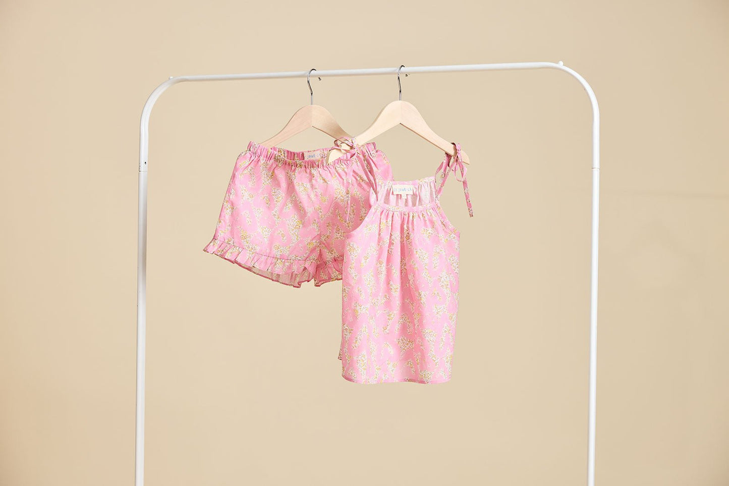 The Rosalie set in Pink hanging from a clothing rail