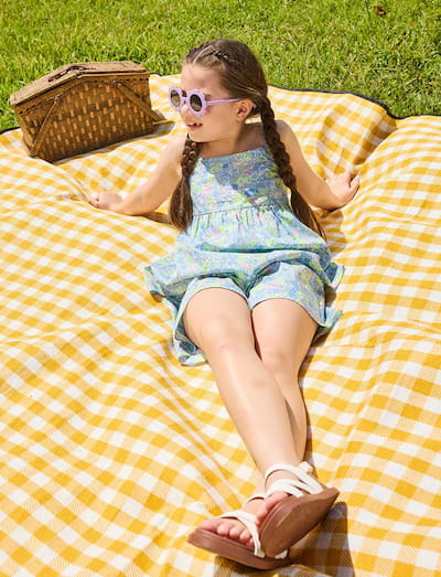 girl lying on blanket wearing ce jour la