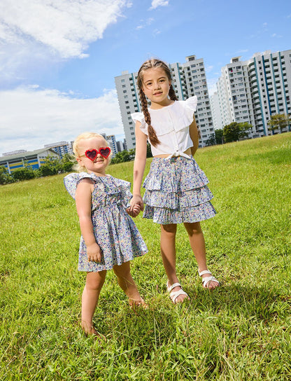Young girl wearing the Daisy dress and heart-shaped sunglasses and a girl wearing the Daisy skirt - ce-jour la