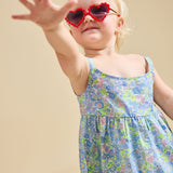 Close up of a girl wearing heart sunglasses modelling the delilah liberty print set - ce-jour la