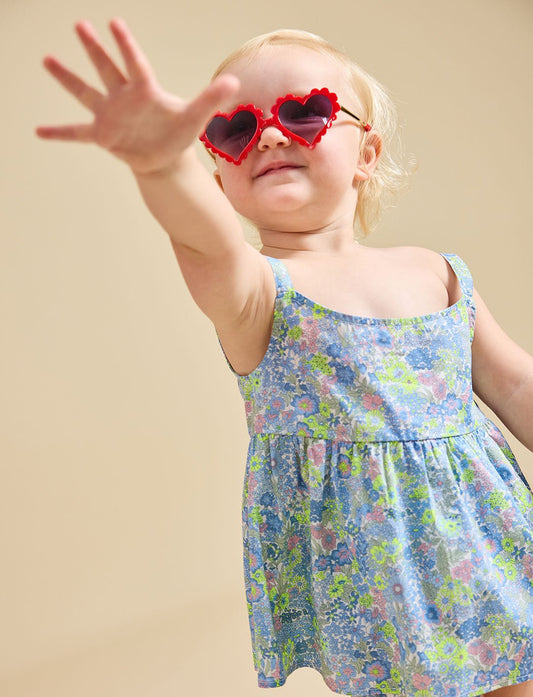 Close up of a girl wearing heart sunglasses modelling the delilah liberty print set - ce-jour la