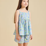 Girl wearing the delilah liberty print set with a beige background