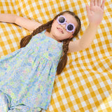 Girl lying on a picnic blanket wearing the delilah liberty print set - ce-jour la