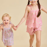 Young girl running towards the camera wearing the ce-jour la fleur dress