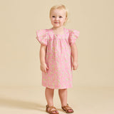 A toddler in a pink floral dress with short, fluttered sleeves and knee-length.