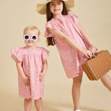 Girls wearing the liberty print Margaux dress in sunglasses and a straw hat