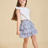 Girl wearing the Odette liberty print skirt with a beige background - ce-jour la