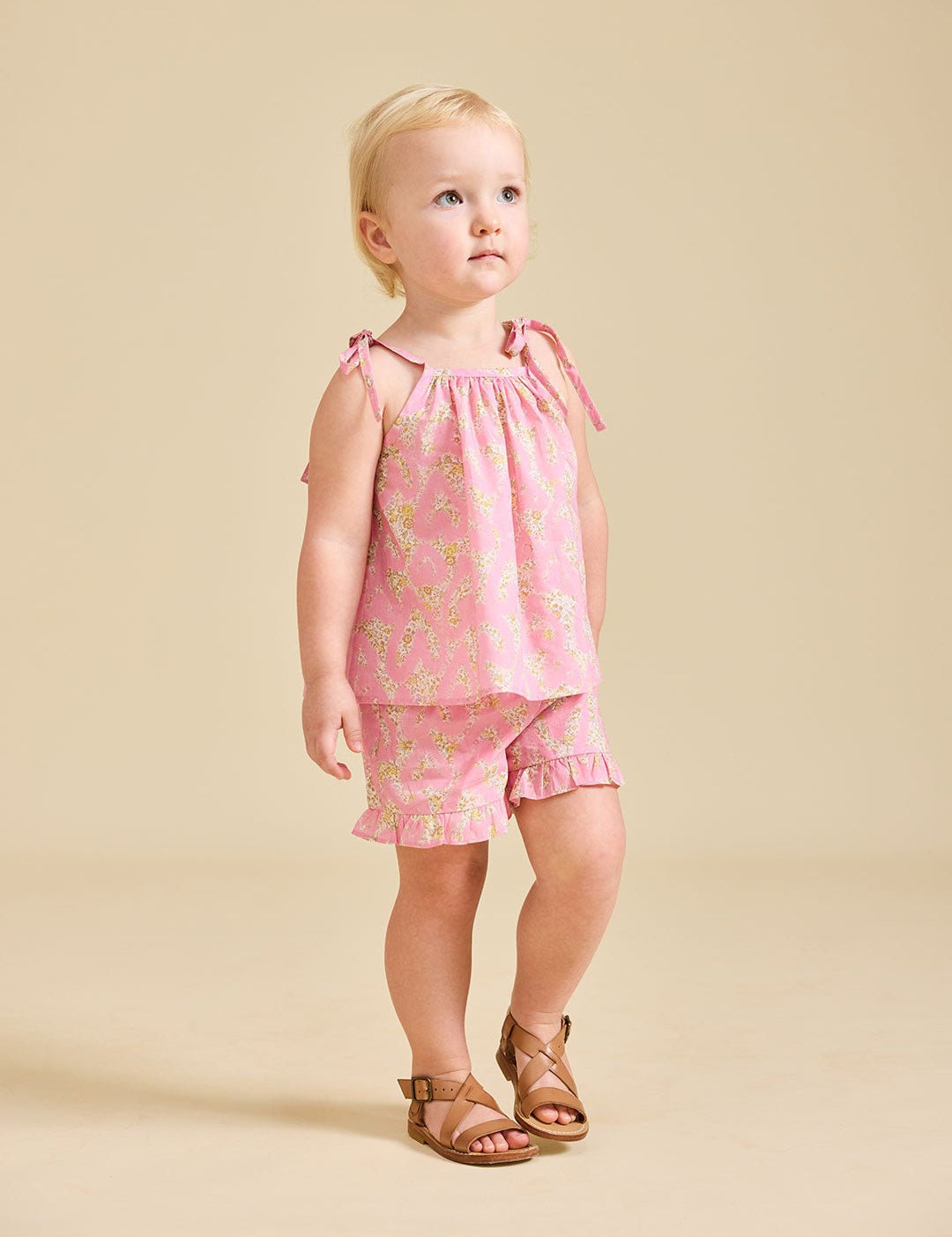 Girl modelling the pink Rosalie set in Liberty fabric and brown sandals - ce-jour la