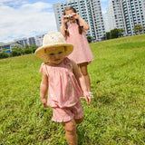 two girls modelling the Rosalie liberty print clothing line in a grassy field