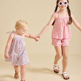 Two girls modelling the Fleur dress and Rosalie set in pink - liberty fabric