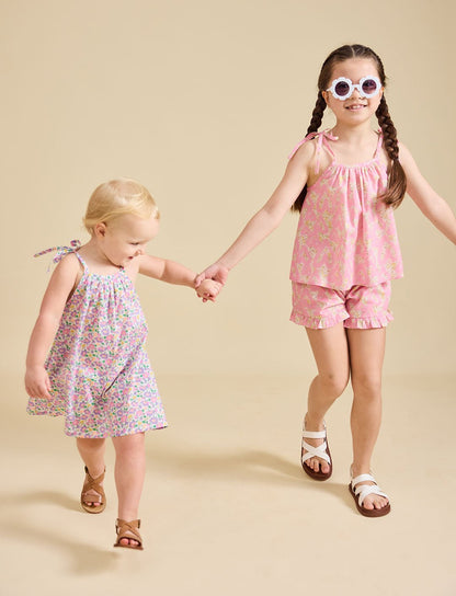 Two girls modelling the Fleur dress and Rosalie set in pink - liberty fabric
