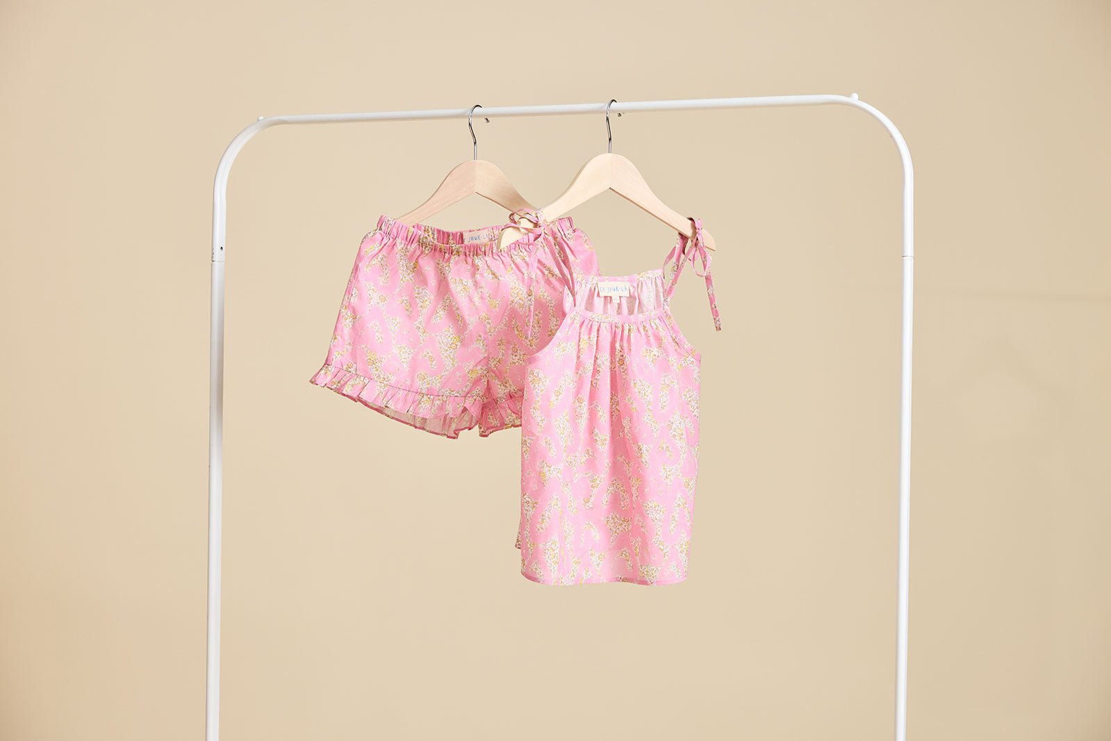 The Rosalie set in Pink hanging from a clothing rail