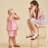 Young girl modelling the Rosalie pink set in liberty fabric